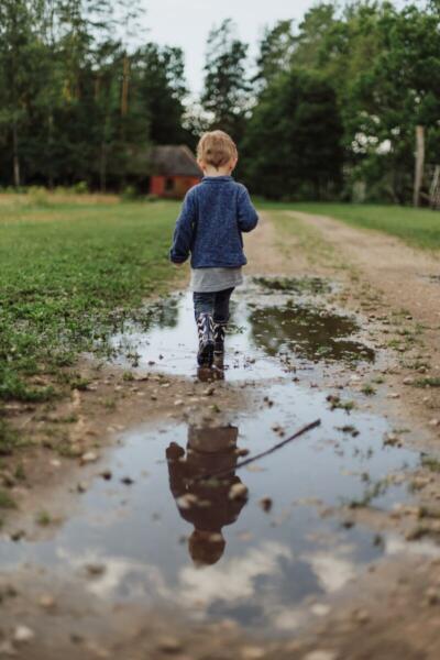 Child playing in puddles