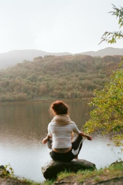 Woman meditating on lake