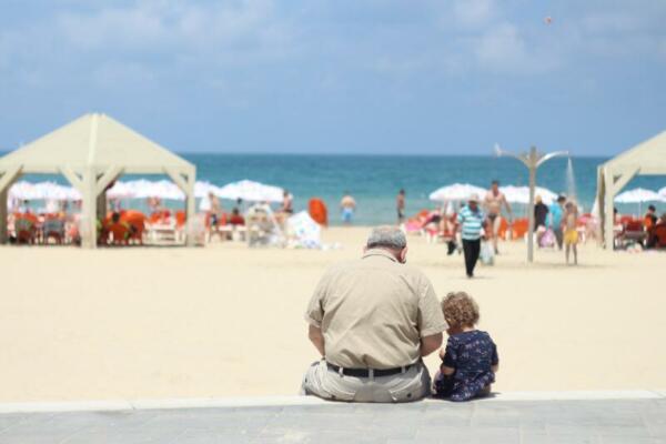 Hrandpa and grandchild on beach