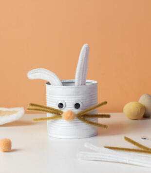 Reuse concept art from tin can. Eco friendly bunny craft. Handmade decoration easter rabbit. Kids DIY ideas.