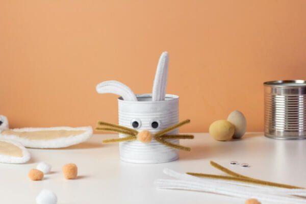 Reuse concept art from tin can. Eco friendly bunny craft. Handmade decoration easter rabbit. Kids DIY ideas.