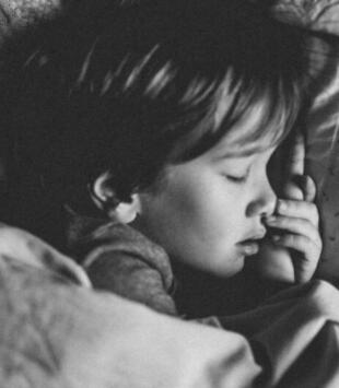 Little boy sleeping, black and white photo